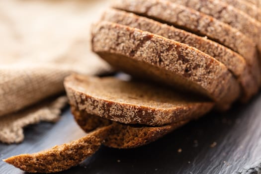 fresh sliced rye bread on a dark background