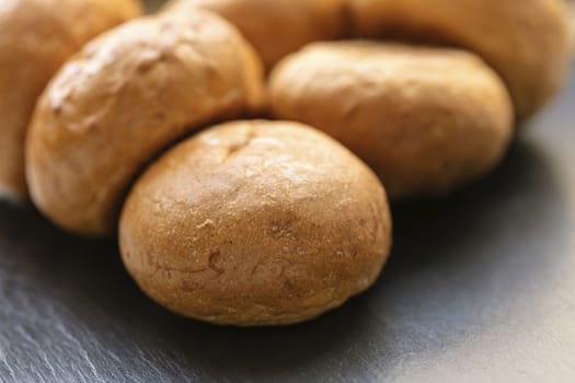 fresh round buns close-up on a black background