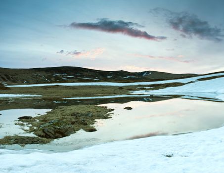 Beauty of Northern nature. Mountain lake in spring landscape