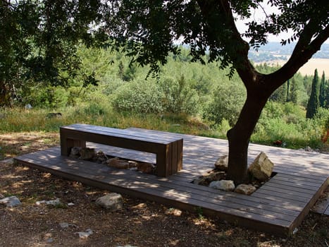 Modern design bench made of wood in a park overlooking beautiful landscape