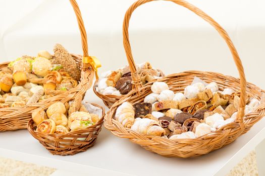 Wicker basket full of delicious sweet and savory baked goods.
