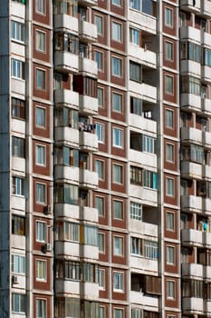 Modern apartment building. Front view. Divercity of windows.