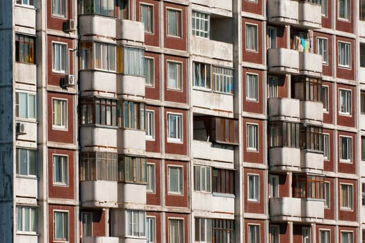 Modern apartment building. Front view. Divercity of windows.