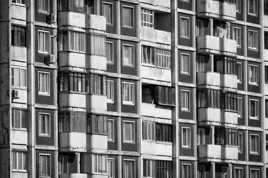 Modern apartment building. Front view. Divercity of windows.