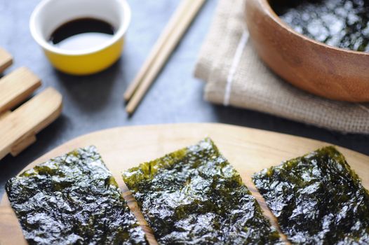 Seaweed wafer snacks on a wooden board closeup