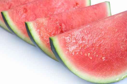 Whole watermelon fruit slices over a white background