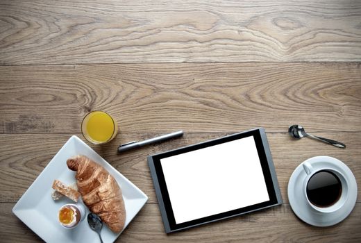 Breakfast with digital tablet on a wooden background with space