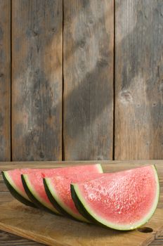 Fresh watermelon slices on a wooden board with menu background