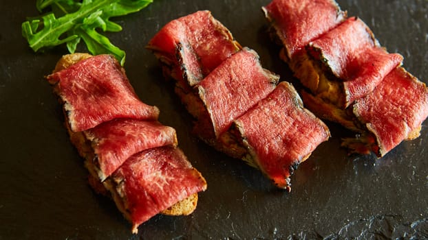 bruschetta with roasted beef and tomatoes. Shallow dof