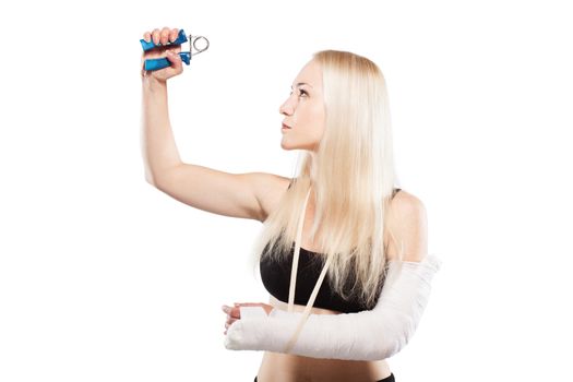 Fitness blond girl with a broken arm in plaster exercising