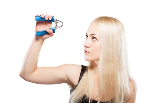 Fitness blond girl exercising her arm with a spring grip tool