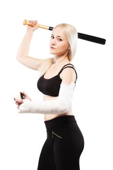 Blond girl with a broken arm in plaster, holding baseball bat and ball