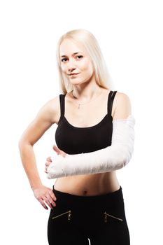 Fitness blond girl with a broken arm in plaster, making thumbs up gesture