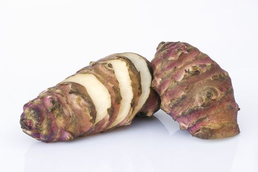 Topinambur root  isolated on white background. Also known as Jerusalem artichoke (Helianthus tuberosus). Edible rhizome native to North America with a taste similar to the artichoke.