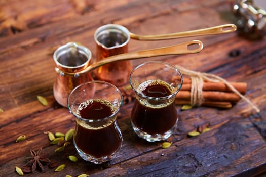 Traditional Arabic coffee. Traditional Arabic coffee. Two copper pots and two glass cups