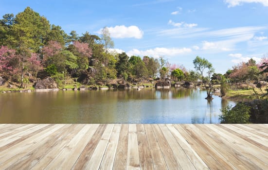 Wood table and river and stone with tree in forest beautiful nature of Asian.