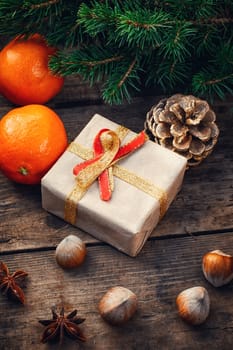 Cardboard box with gift for Christmas,pinecone,tangerines and fir