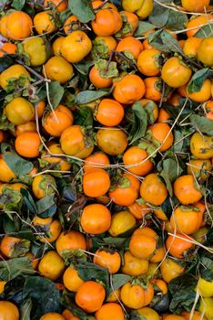 Kaki fruits for sale on a market stall