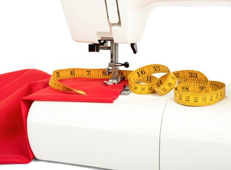 Sewing machine with fabric and tape on white background. Close-up