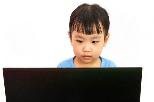 Chinese little girl using laptop in plain isolated white background.