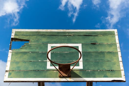 basketball hoop old and deteriorate on blue sky with cloud