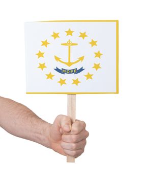 Hand holding small card, isolated on white - Flag of Rhode Island