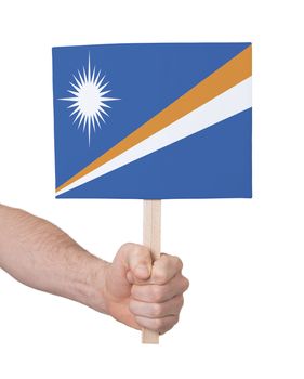 Hand holding small card, isolated on white - Flag of Marshall Islands
