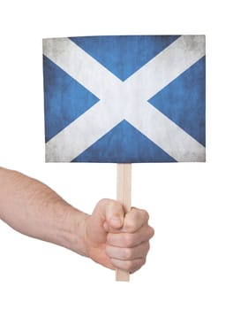 Hand holding small card, isolated on white - Flag of Scotland