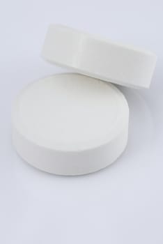 white pills on a white background 