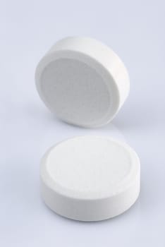 white pills on a white background 