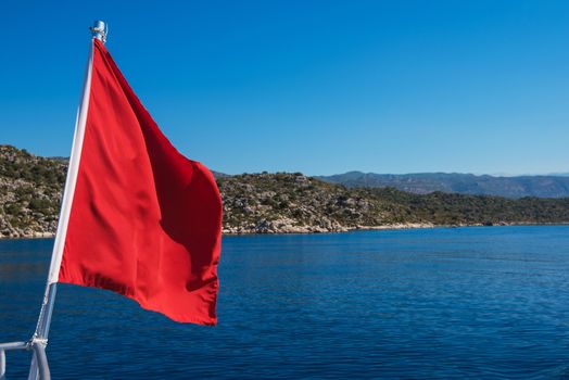 Red Flag from yacht, on sea background