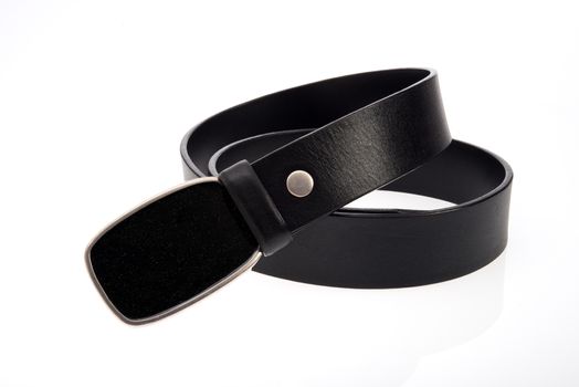 Leather black belt with metal black buckle on white background