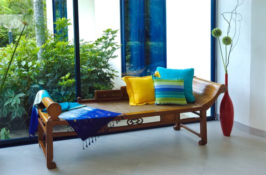 Thai silk fabric and pillows on wooden antique sofa chairs