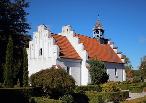 Old traditional village church at a graveyard