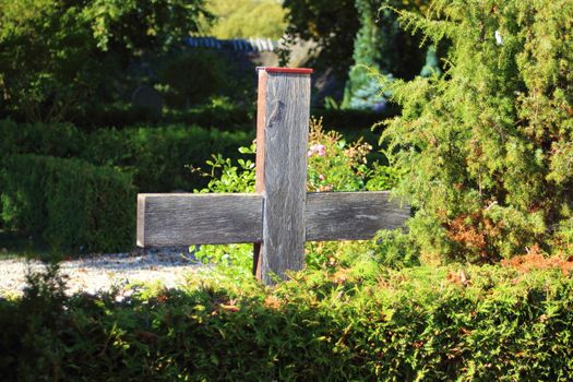 Simple wooden cross at an old graveyard in Denmark