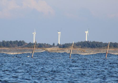 Offshore fishing net and coast line with windmills