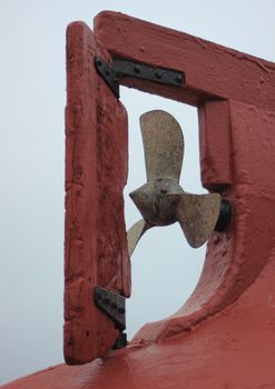 Trawler put upside down with detail of propeller and rudder