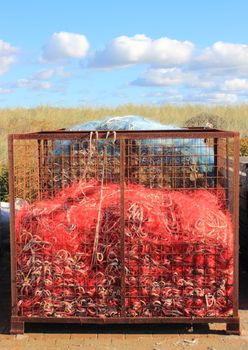 Red industry fishing net in rusty metal grid