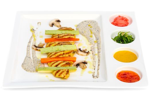 Grilled chicken fillet and squash with several additions such as seaweed chuka, pickled ginger and three kinds of sauces on square white plate