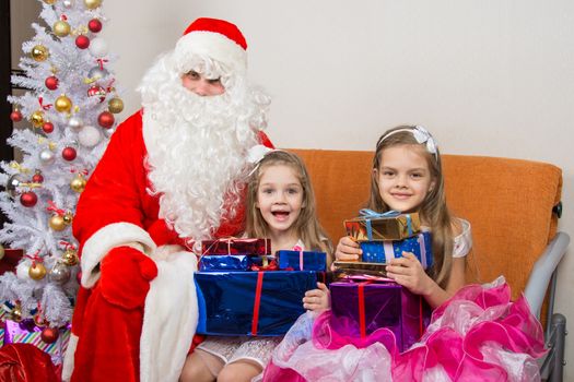 Santa Claus gave presents to the children, and together looked in the frame