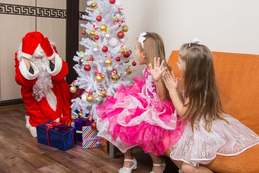 Two girls saw Santa Claus who brought them gifts