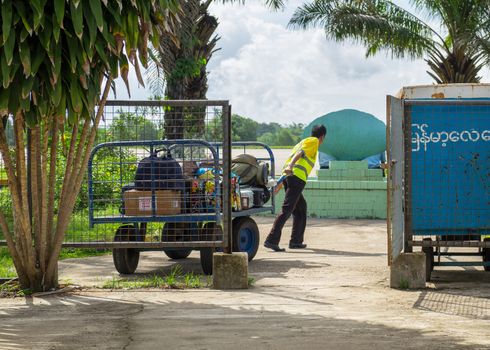 Myeik, Myanmar - June 8, 2016: Due to lacking road and railway infrastructure, Myanmar relies heavily on air transport for travelling. Technology is often basic, like the baggage handling at Myeik Airport in Tanintharyi Region.