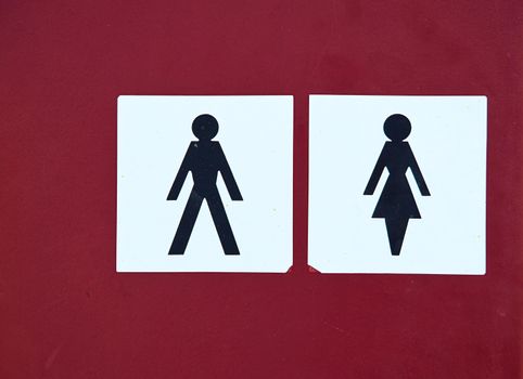 Toilet symbol sign on for men and women on red background