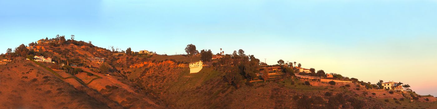 Malibu hillside at sunset above the Pacific Ocean coastline in California, United States.