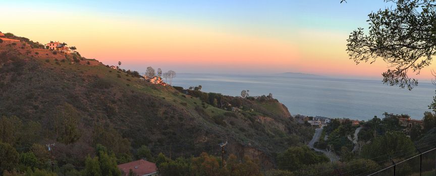 Malibu hillside at sunset above the Pacific Ocean coastline in California, United States.