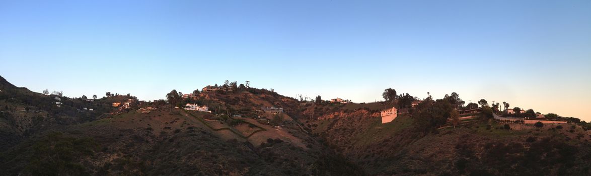 Malibu hillside at sunset above the Pacific Ocean coastline in California, United States.