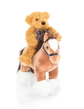 Teddy bear riding a horses on white background