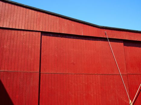 Red old vintage barn in a farm agriculture background image         