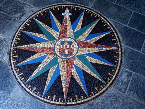 Beautiful compass directions wind rose made from colorful mosaic stones