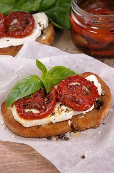 Bruschetta with feta and sun-dried tomatoes slices spiced